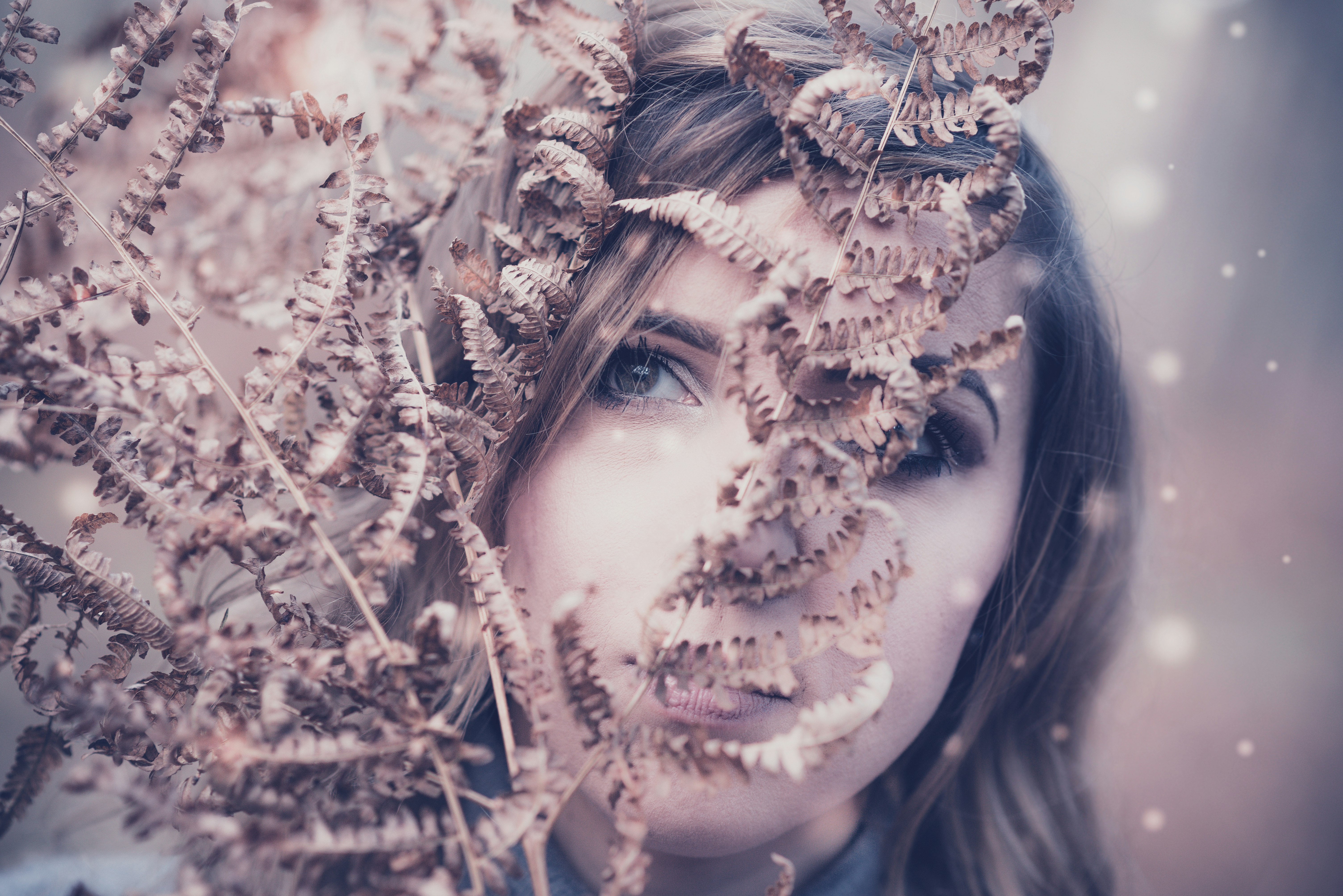 woman behind brown plant